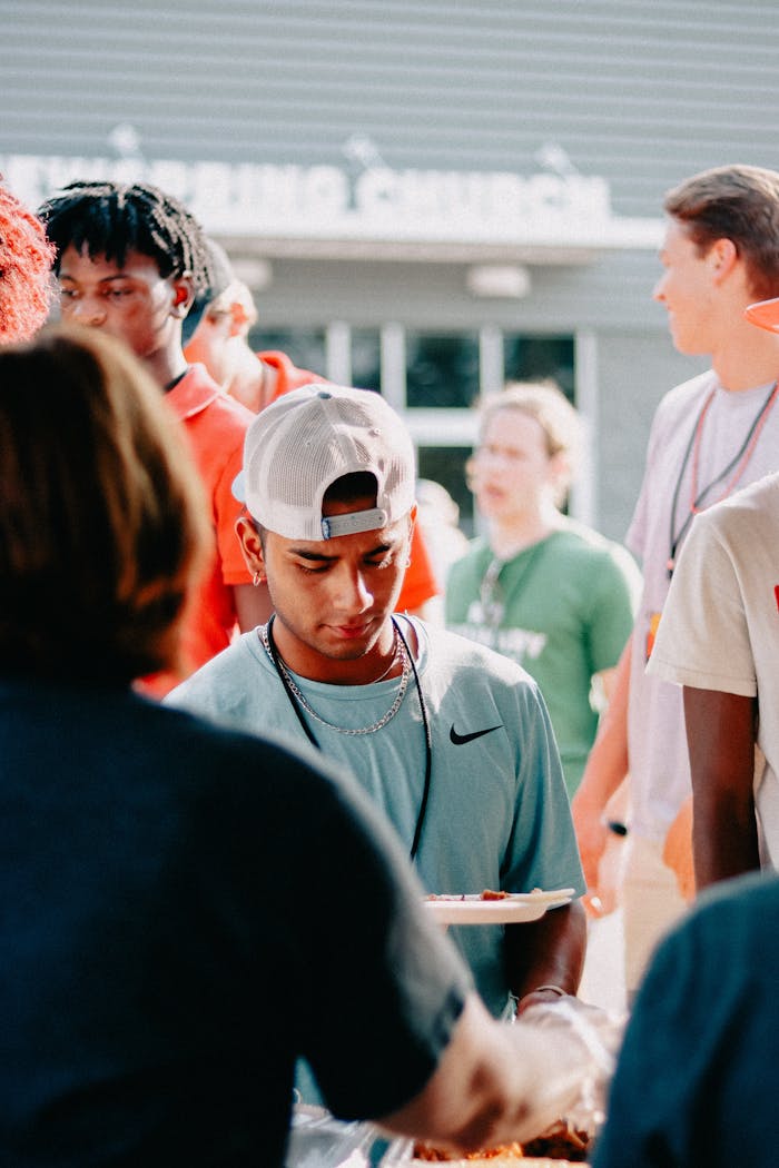our-experience People enjoying an outdoor church event with food and fellowship.